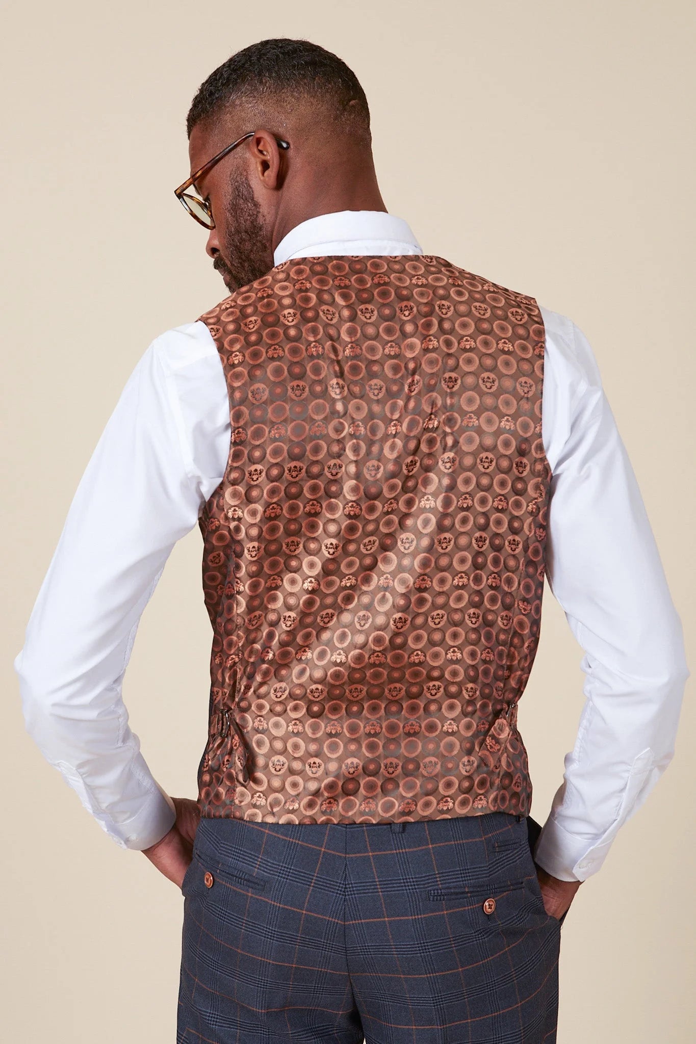 Man wearing a patterned vest over a white shirt