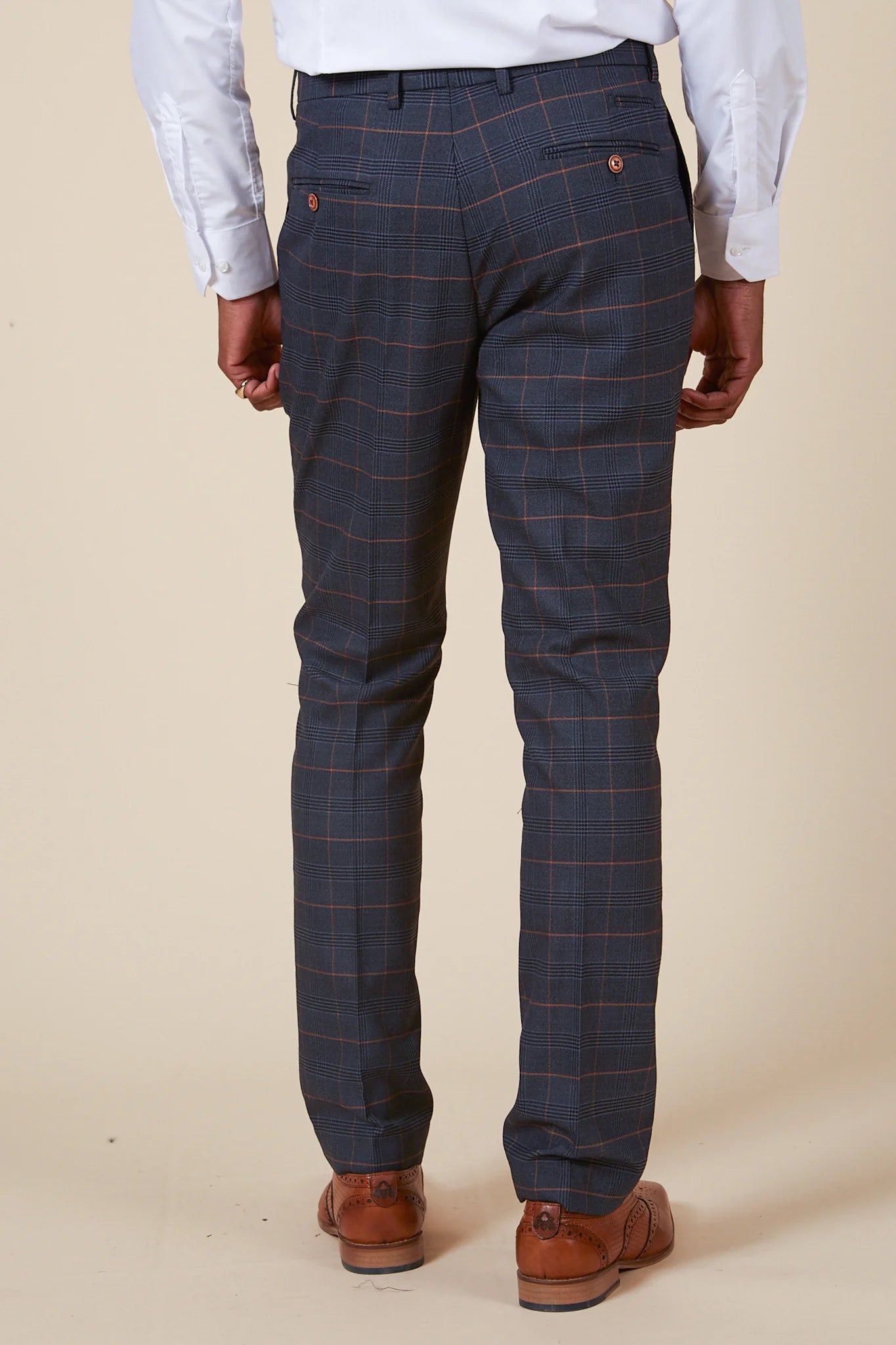 Blue checkered pants worn by a person on a plain background