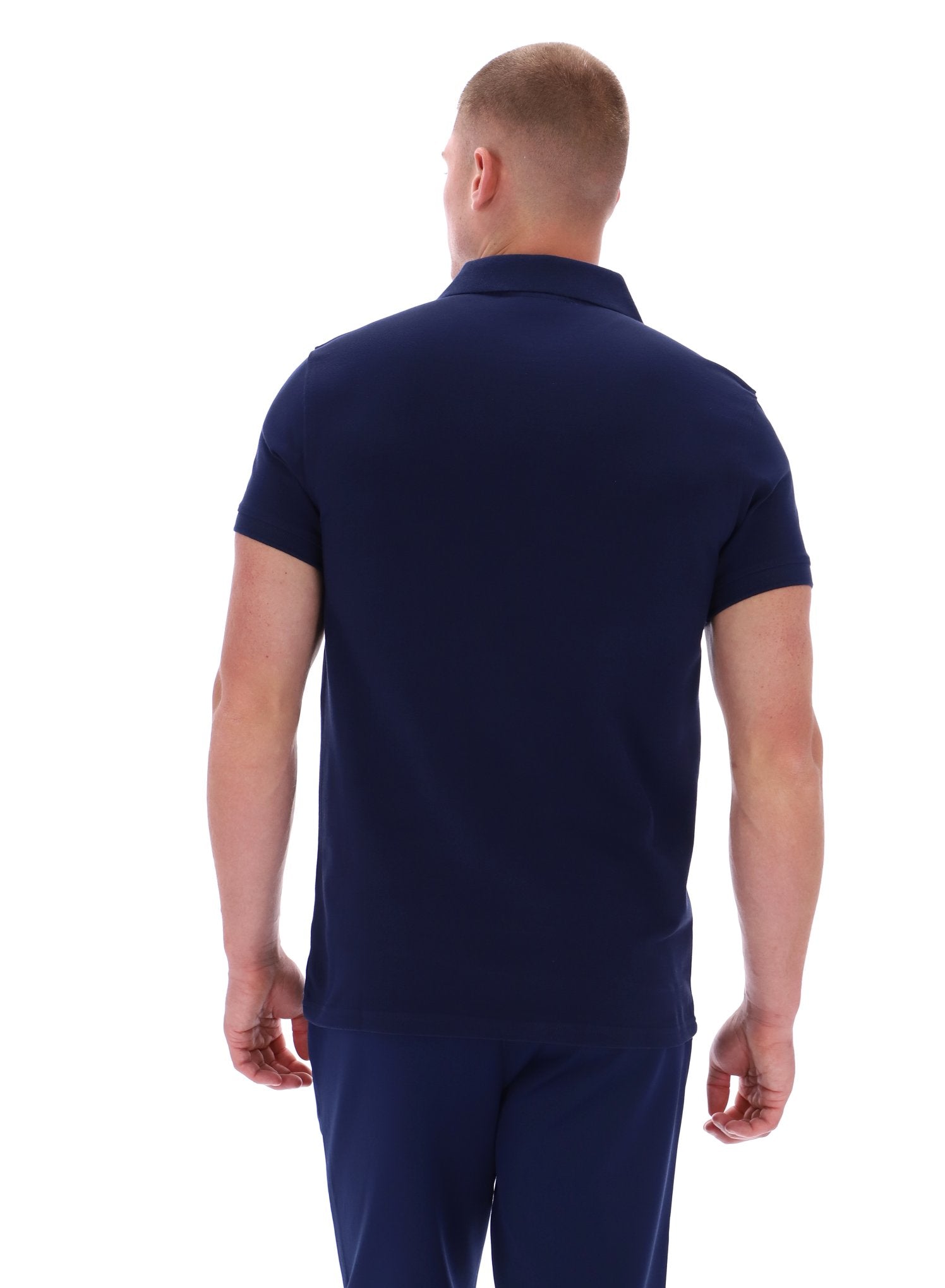 Man wearing a navy blue polo shirt and pants on a white background