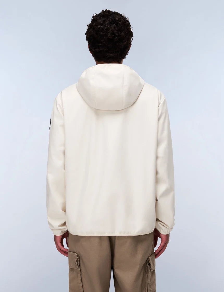 Person wearing a beige puffer jacket and brown pants on a light gray background