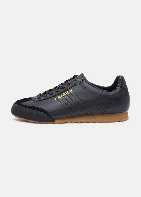 A pair of black Patrick Villan trainers with a lace-up front, rubber outsole, and gold signature logo.