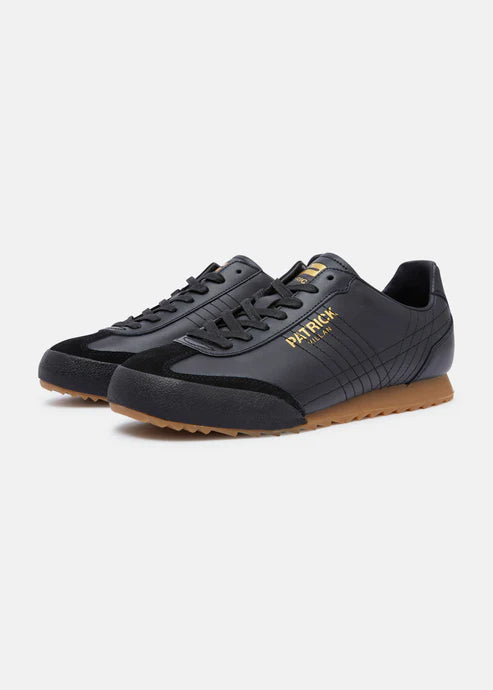 A pair of black Patrick Villan trainers with a lace-up front, rubber outsole, and gold signature logo.