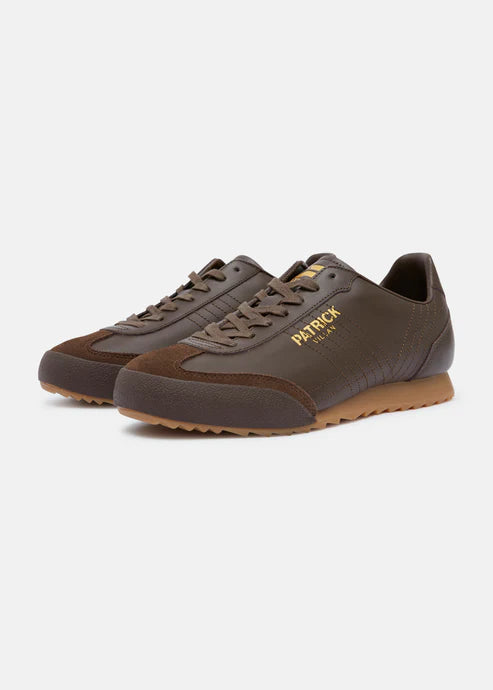 A pair of black Patrick Villan trainers with a lace-up front, rubber outsole, and gold signature logo.