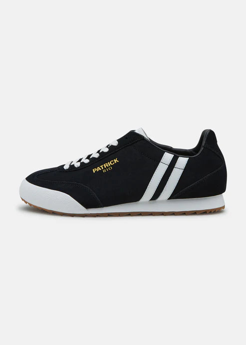 A black and white Patrick Rio trainer shoe with a suede upper and a rubber sole, featuring a contrast striped panel and a gold Patrick logo.