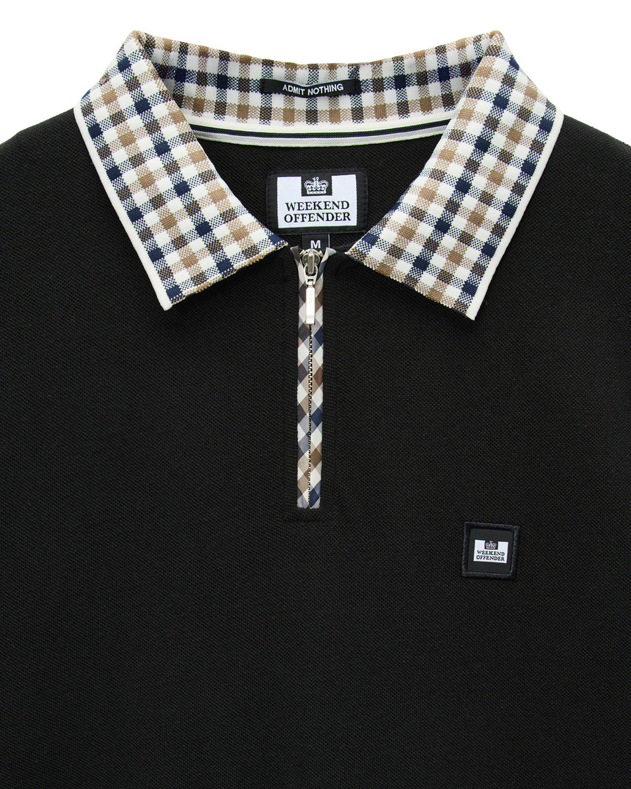 Black polo shirt with checkered collar and Weekend Offender branding