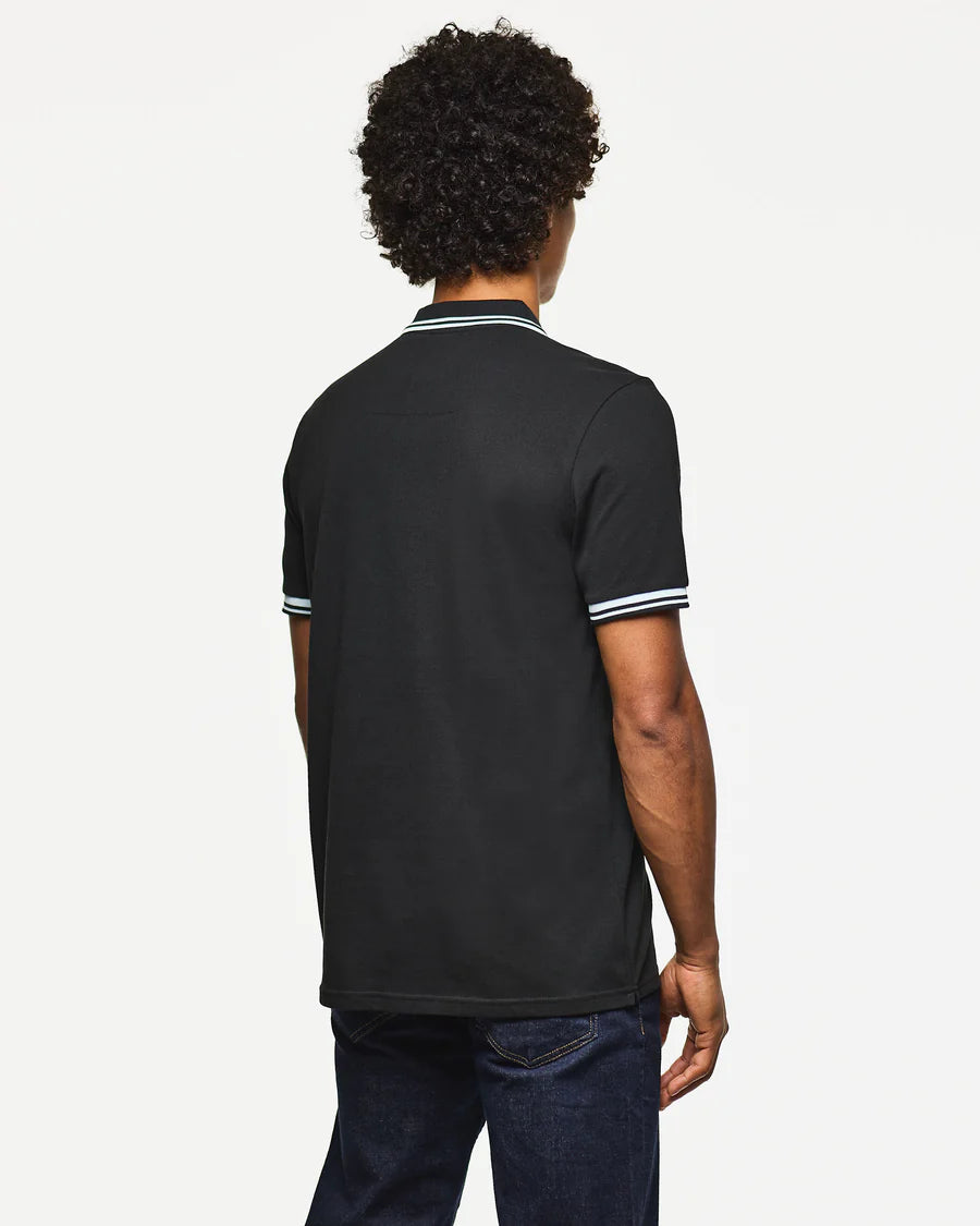 Person wearing a black polo shirt with white trim on a white background