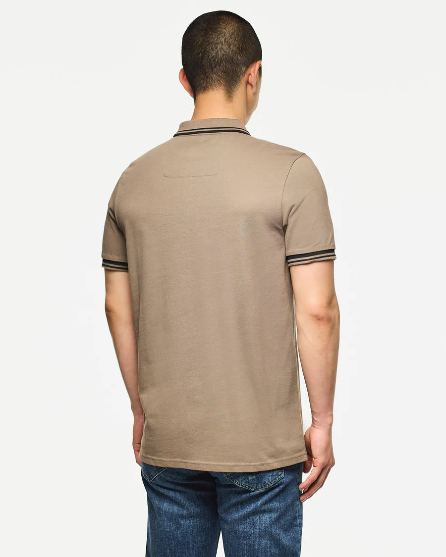 Man wearing a beige polo shirt on a white background