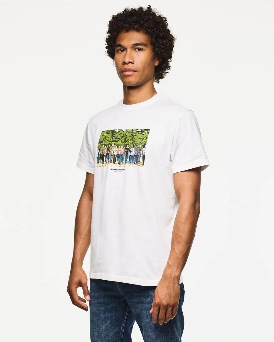 Man wearing a white t-shirt with a graphic design on a plain background