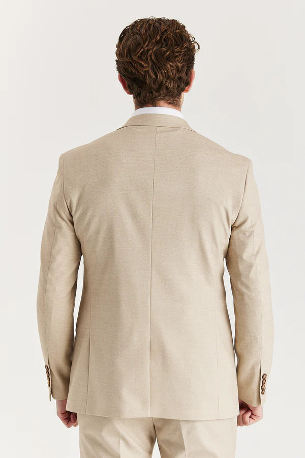 Man wearing a beige suit jacket on a white background