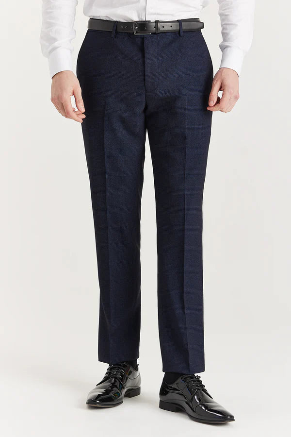Navy suit pants worn by a person on a white background