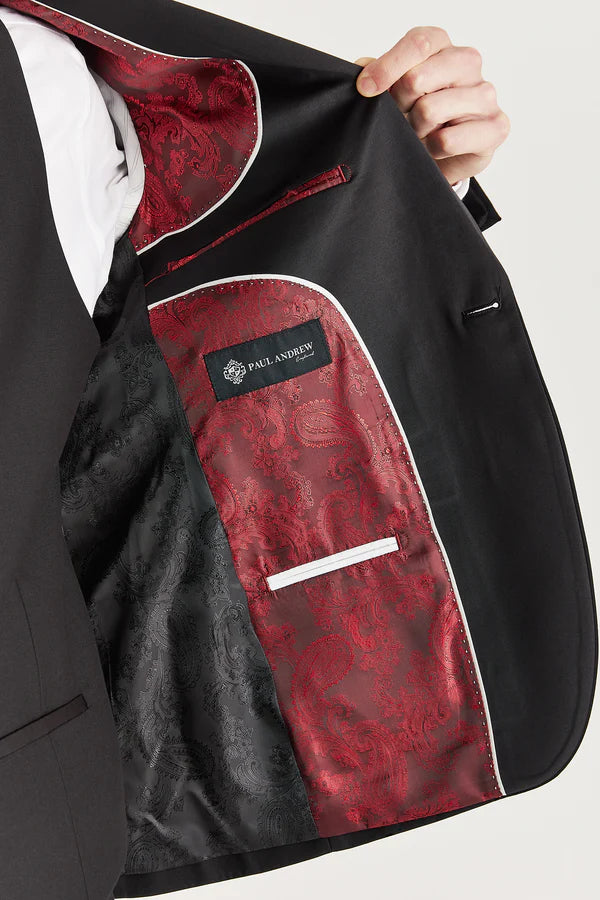 Black suit jacket with red interior lining and Paul Andrew label on a white background