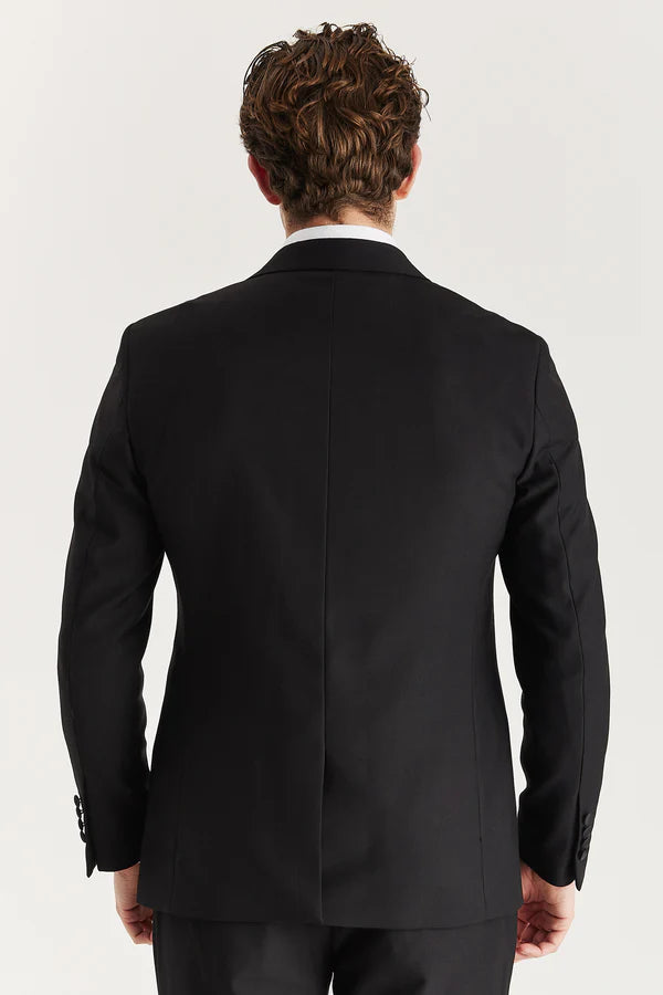 Person wearing a black suit jacket on a white background