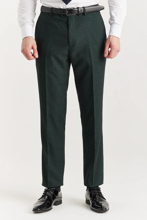 Dark green dress pants worn by a person on a white background