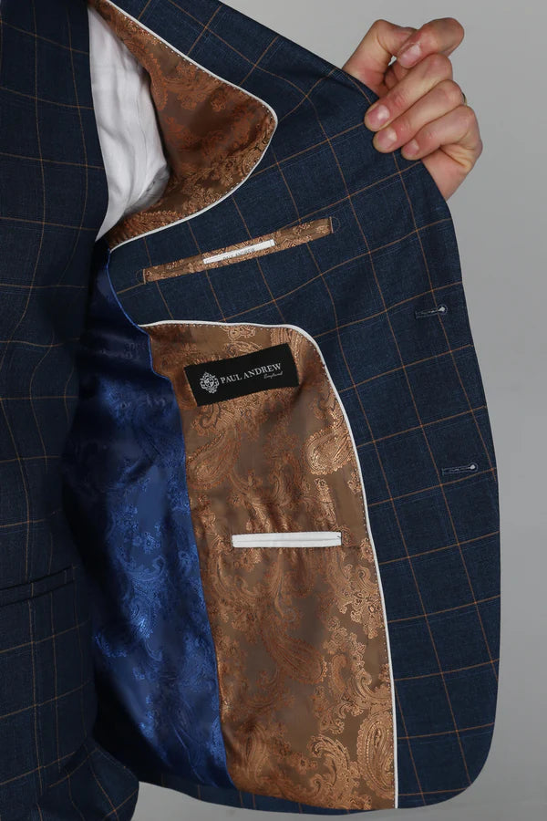 Navy suit jacket with brown lining held open to reveal brand label