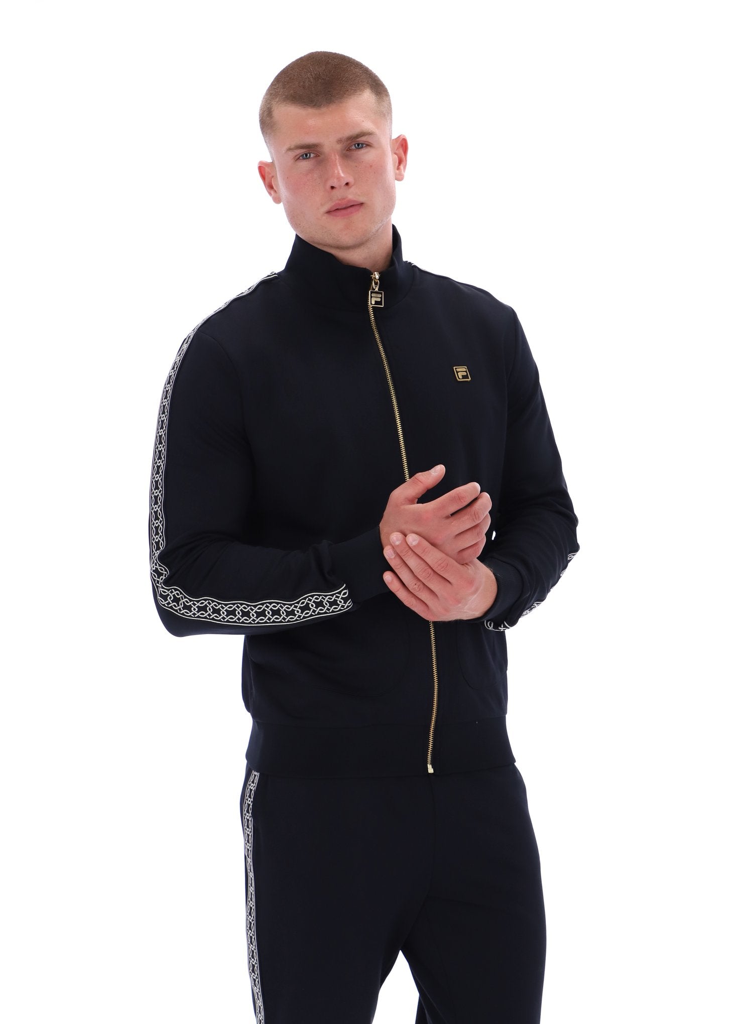 Man wearing a black tracksuit with white patterns on a white background