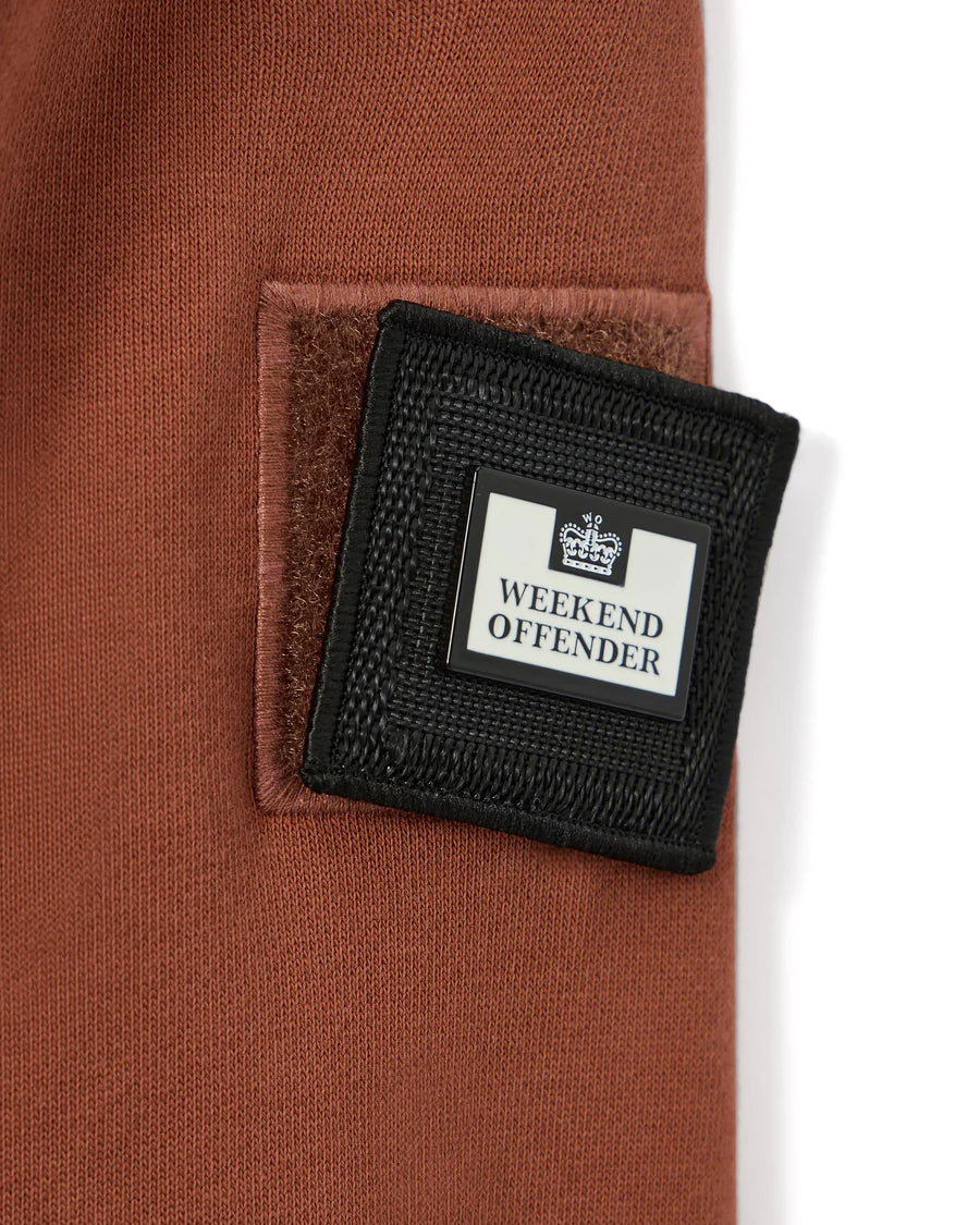 Black wallet with 'Weekend Offender' branding on a brown background