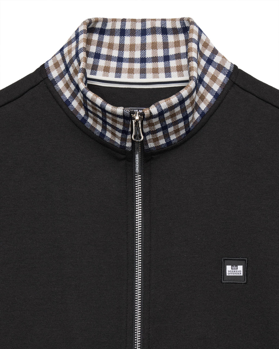 Black jacket with plaid collar and zipper detail on a white background