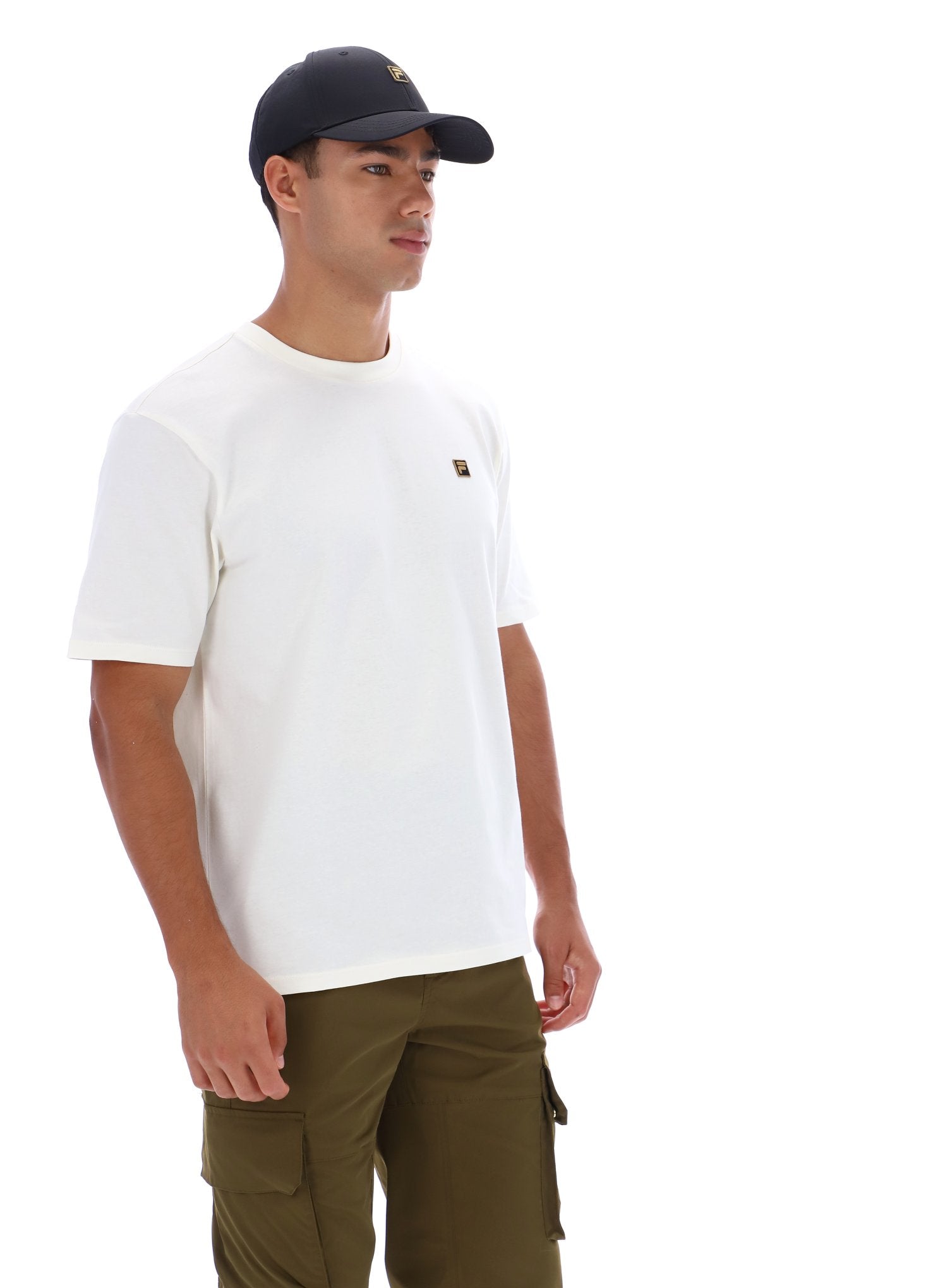 Man wearing white t-short, khaki trousers, and a black baseball cap on a white background