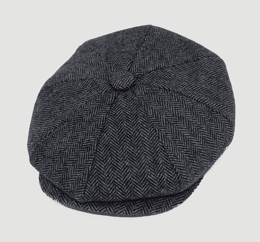 Herringbone patterned flat cap on a light gray background