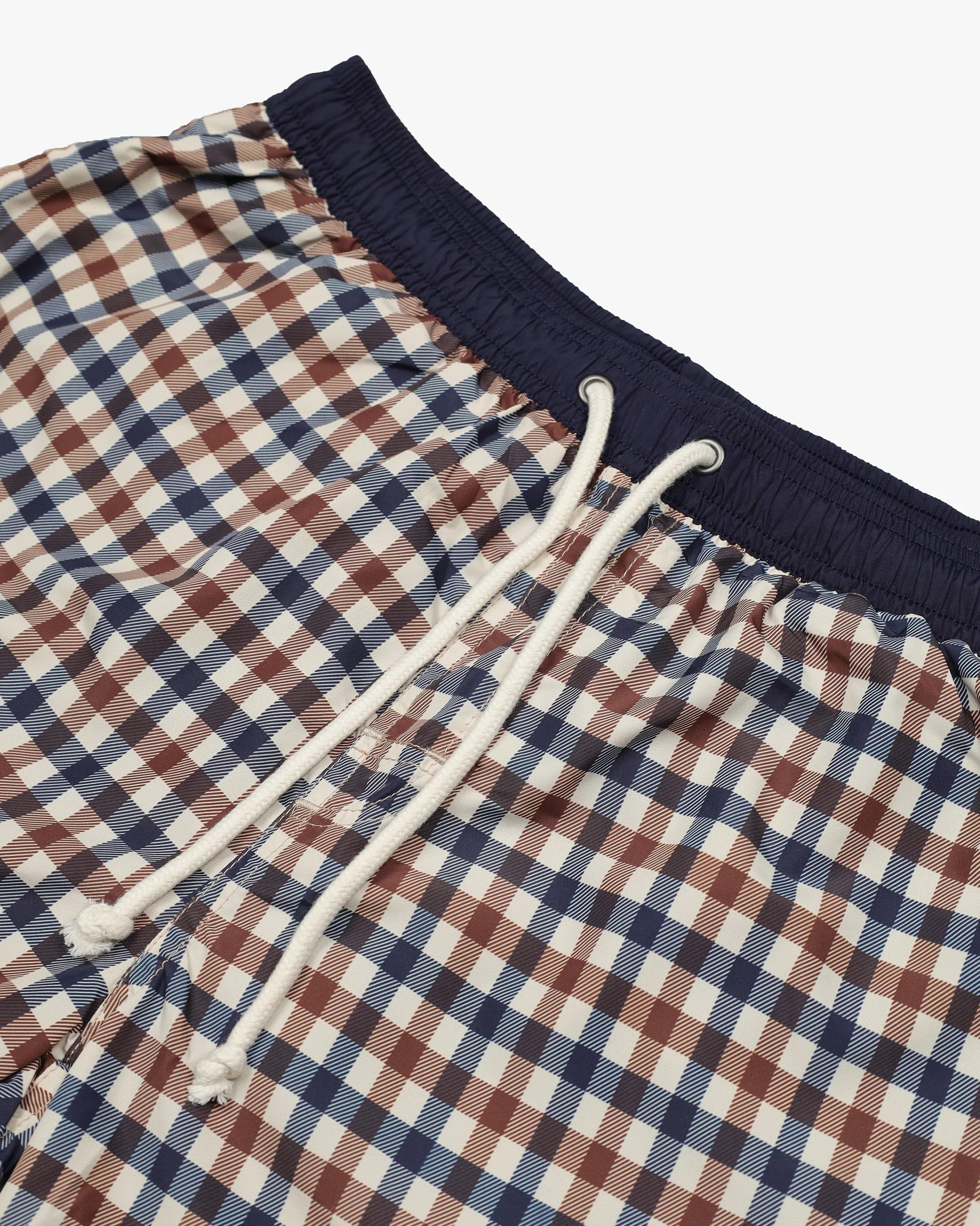Close-up of plaid shorts with a drawstring on a white background