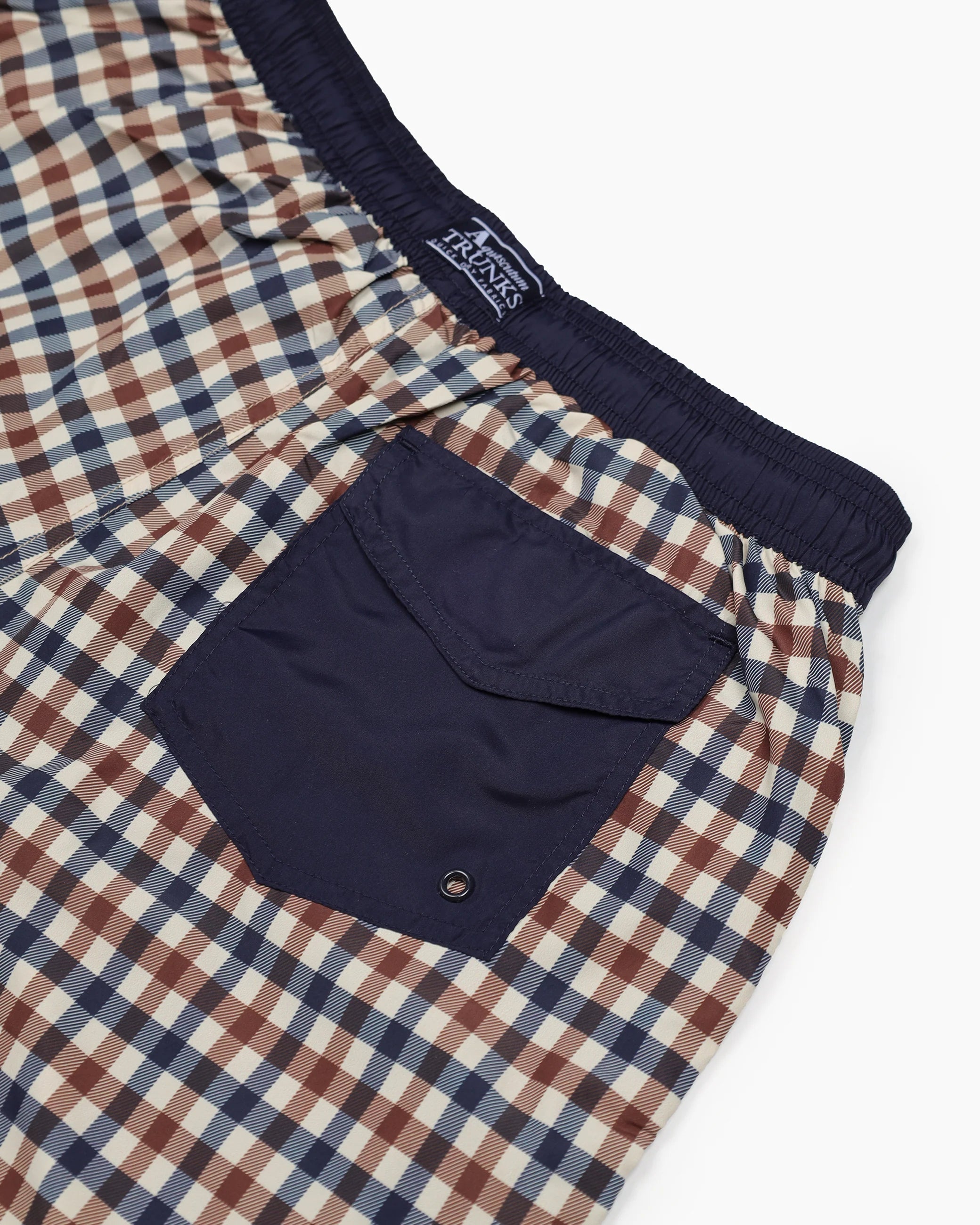 Plaid shorts with a navy pocket on a white background