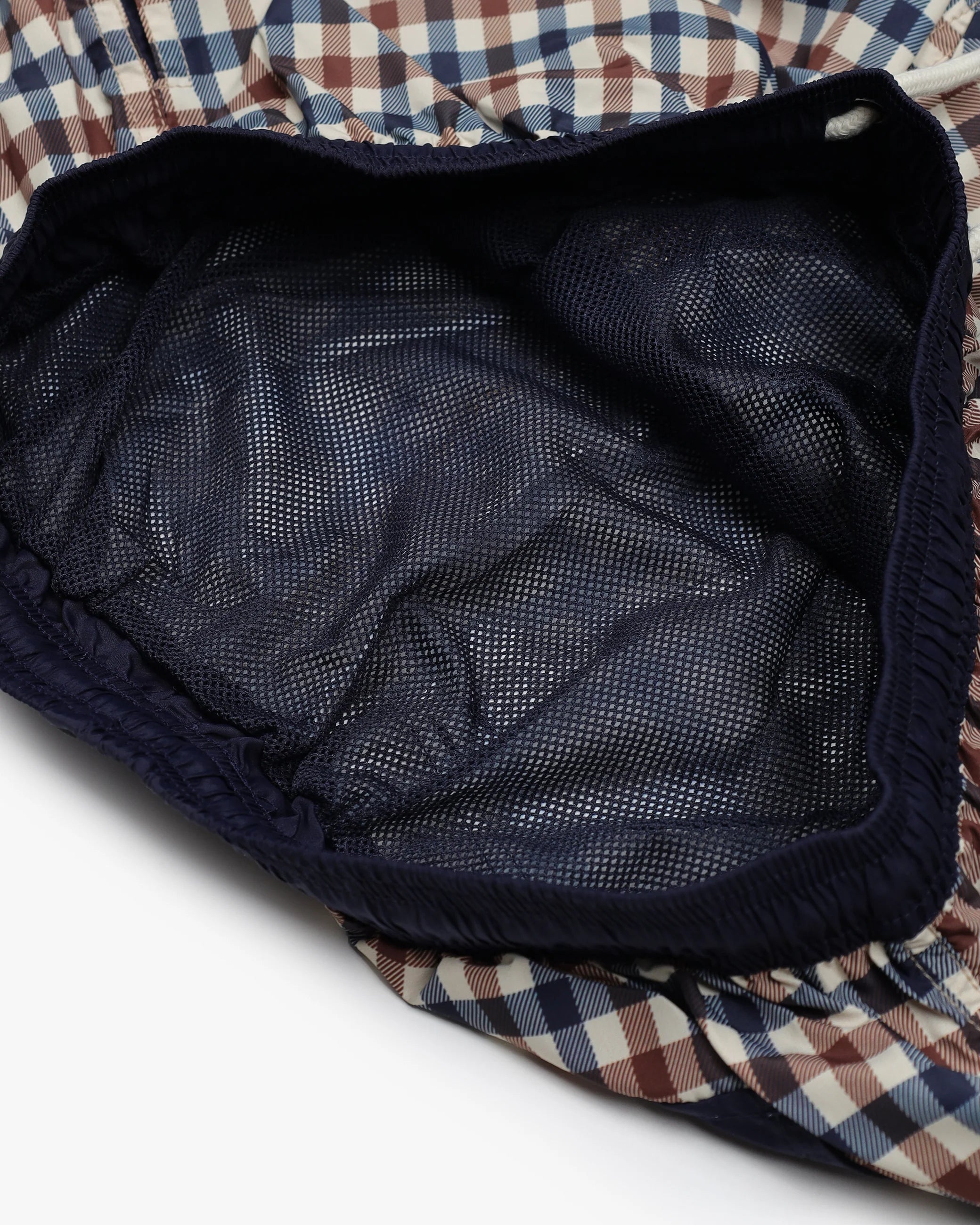 Navy quilted jacket lining with plaid fabric visible
