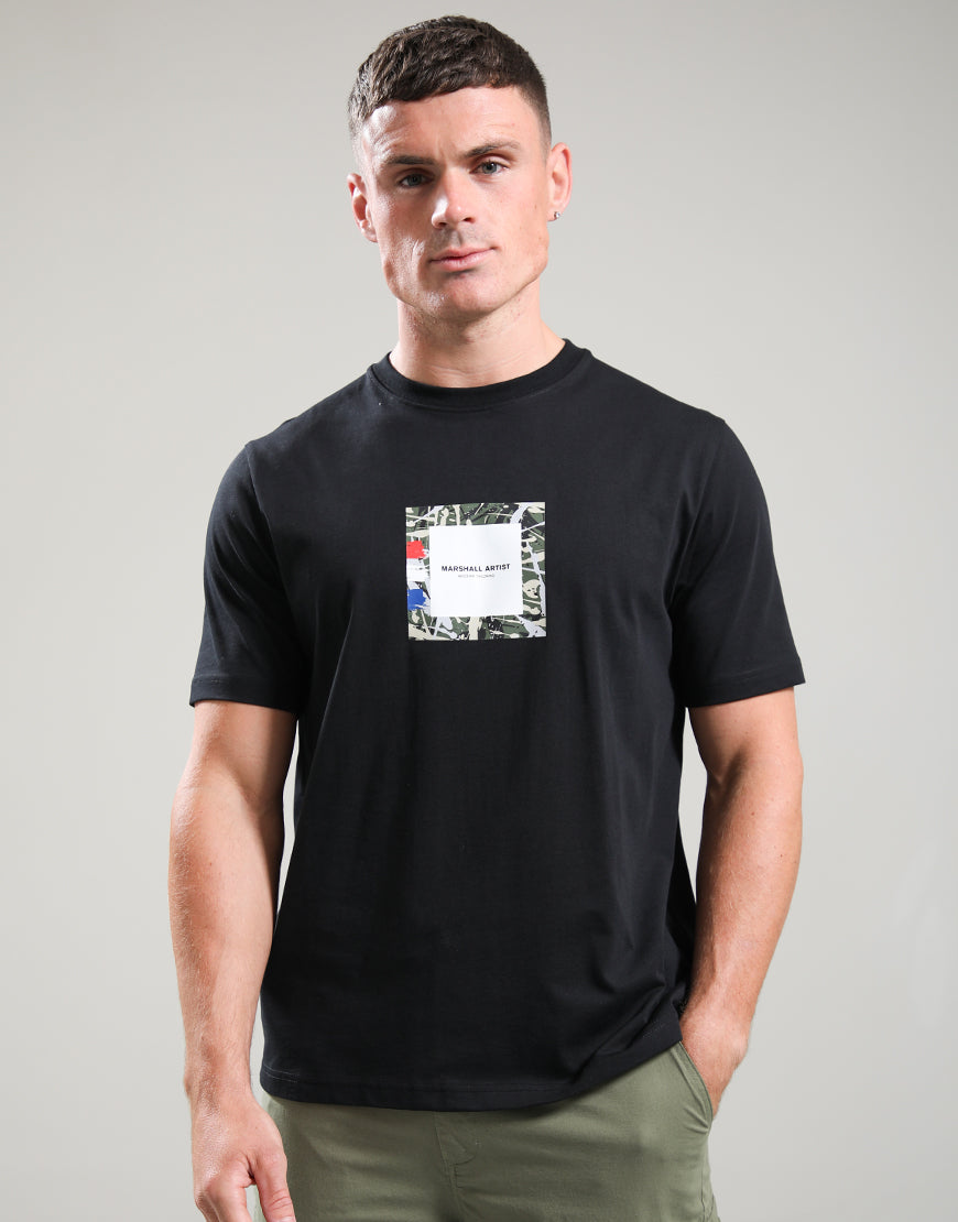 Man wearing a black t-shirt with a graphic design on a gray background