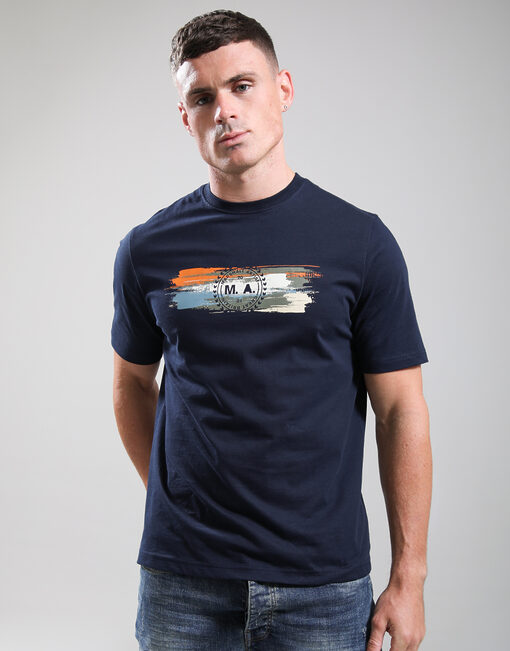 Man wearing a navy blue t-shirt with a graphic design on a gray background