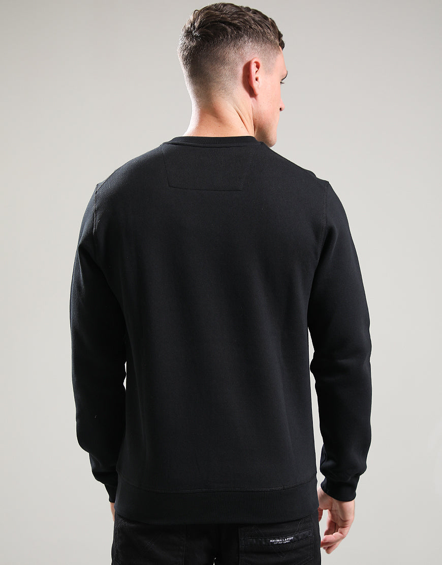Person wearing a black sweatshirt on a gray background