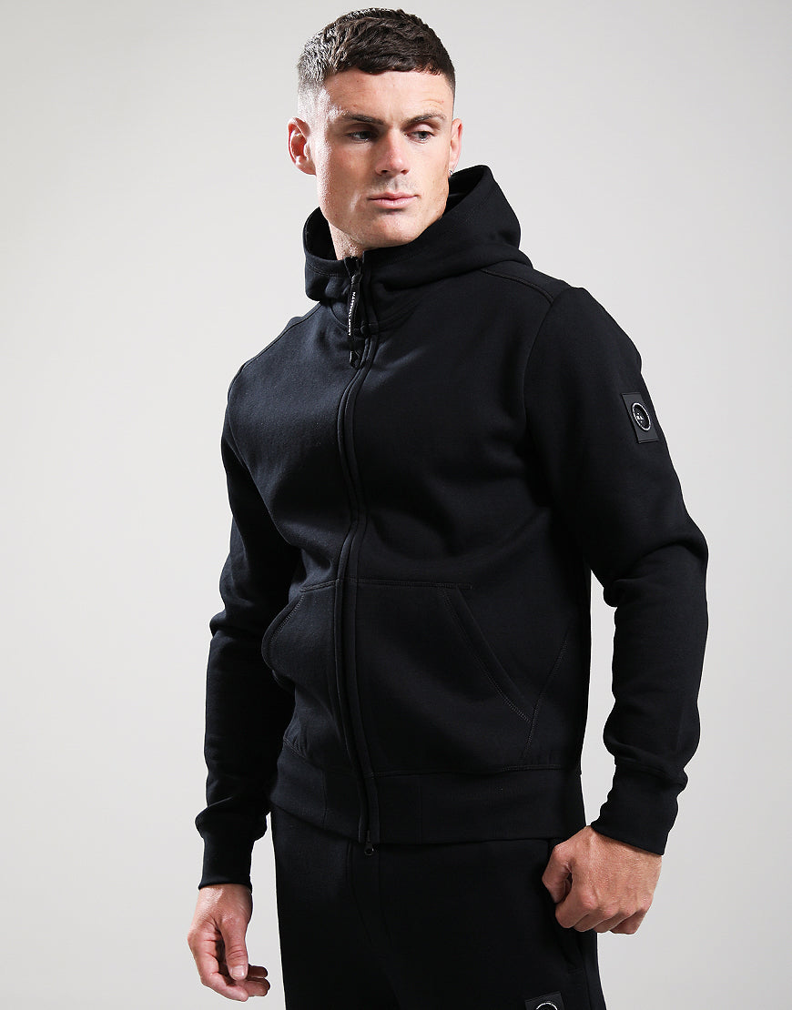 Man wearing a black hoodie on a gray background