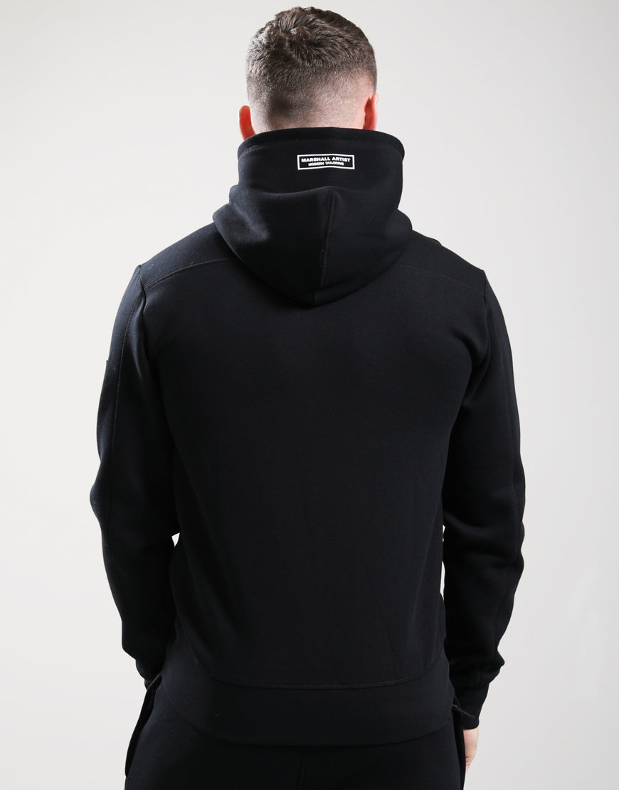 Person wearing a black hoodie with a visible brand logo on the back against a white background