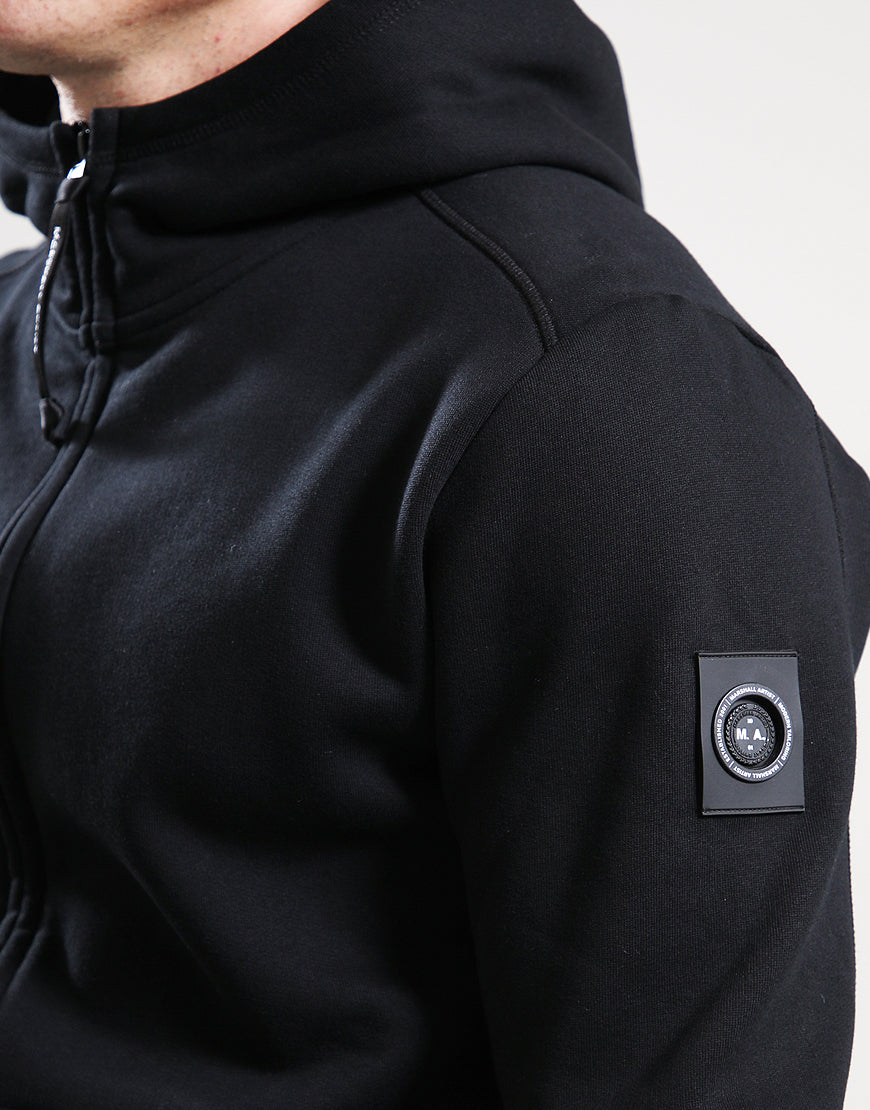 Black hoodie with a brand logo on the sleeve against a neutral background