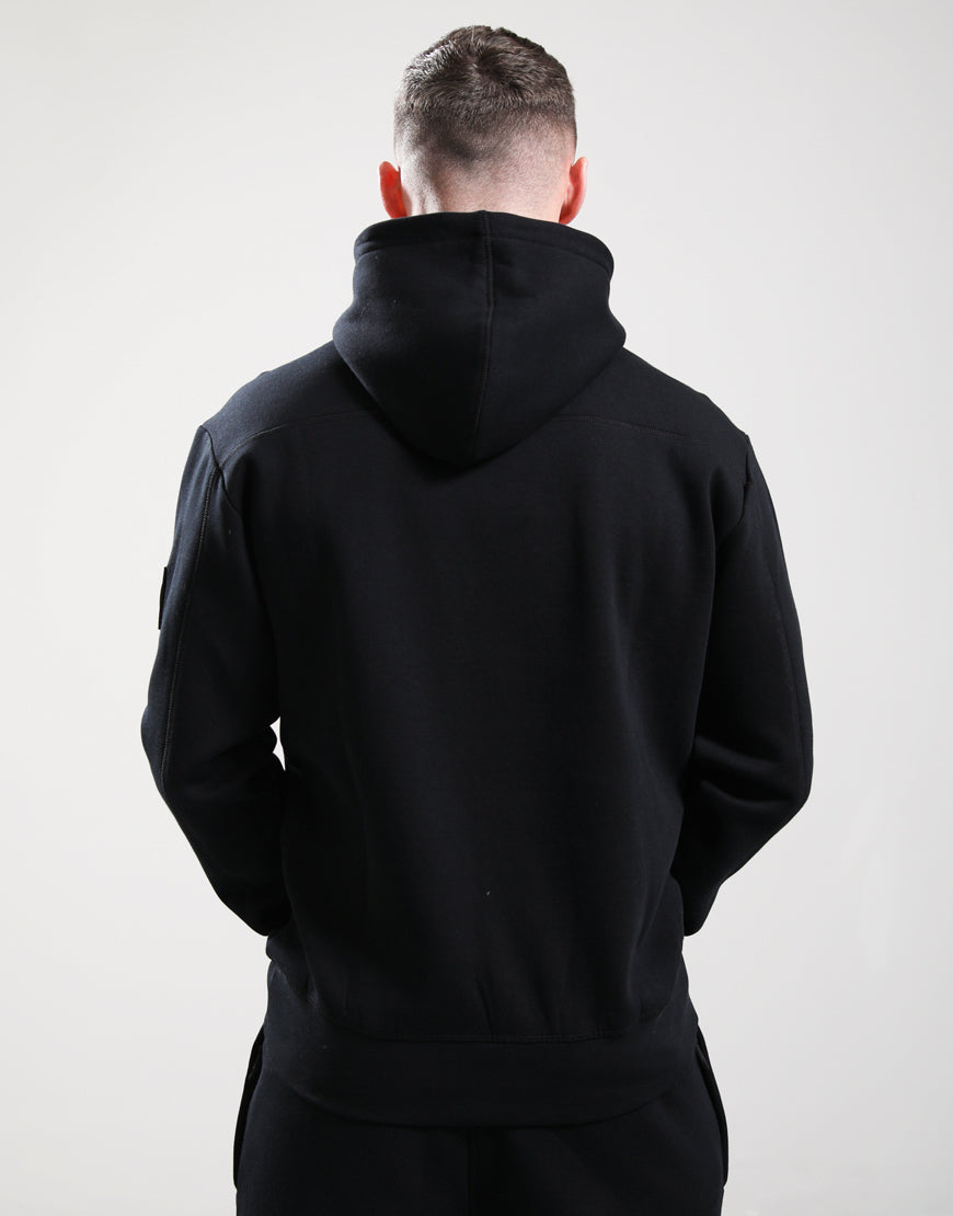 Person wearing a black hoodie from behind on a white background
