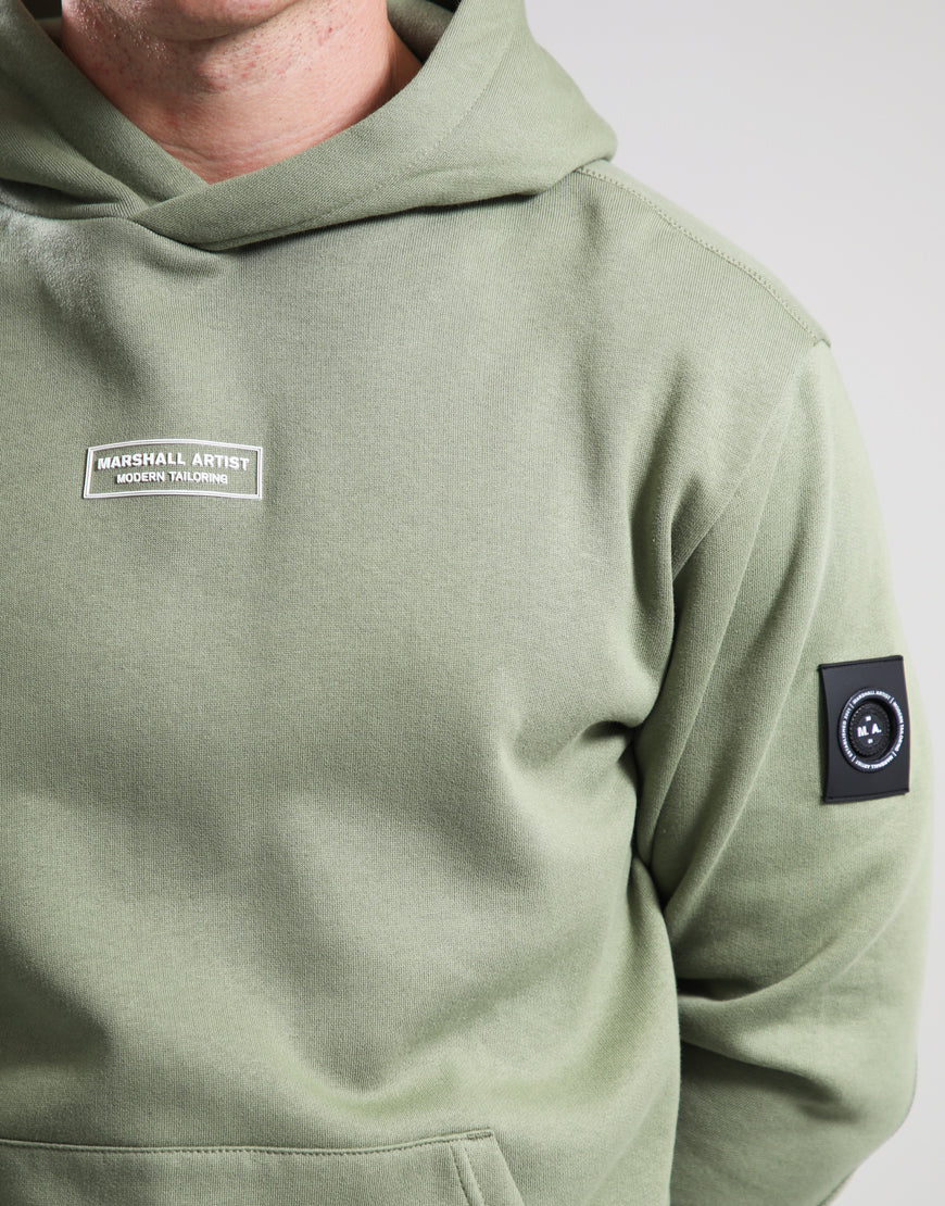 Green hoodie with visible branding on a plain background