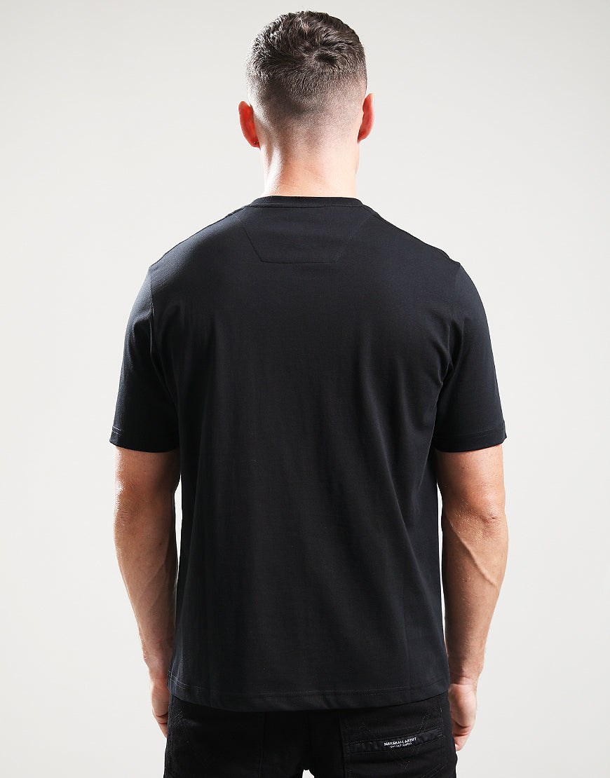 Person wearing a black t-shirt with a visible brand logo on the back against a white background