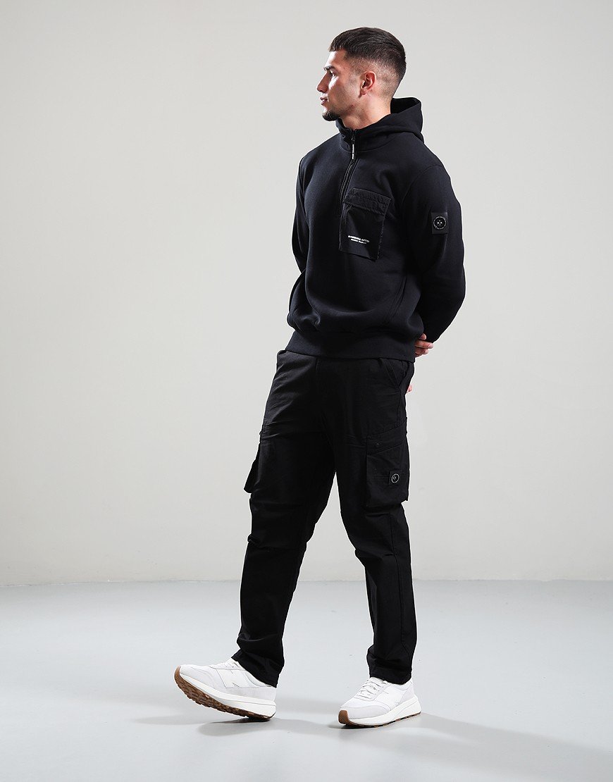 Person wearing a black hoodie and cargo pants on a white background