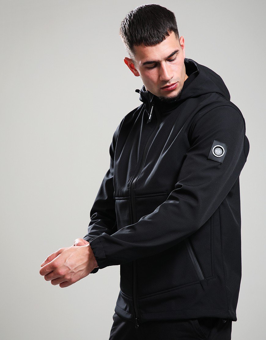 Man wearing a black jacket with a brand logo on a gray background