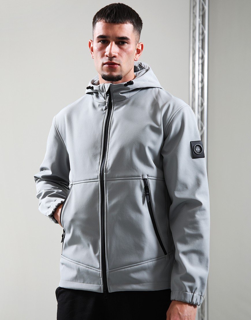 Man wearing a gray jacket with a brand logo on a plain background