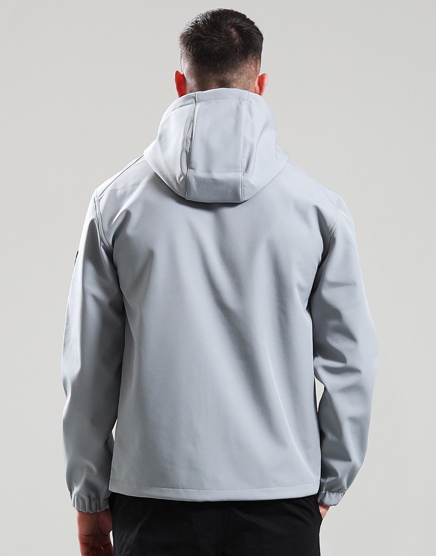 Person wearing a light gray jacket with a hood on a plain background