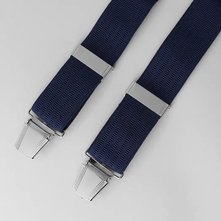 Two navy blue suspenders with silver clips on a light gray background