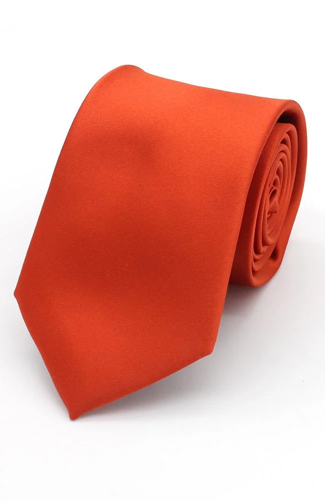 A rolled-up plain satin burnt orange tie.