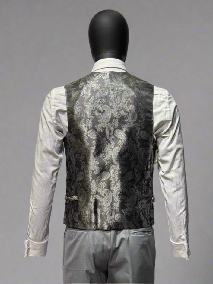 Mannequin wearing a patterned vest over a white shirt on a gray background