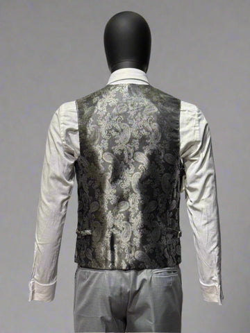 Mannequin wearing a patterned vest over a white shirt on a gray background