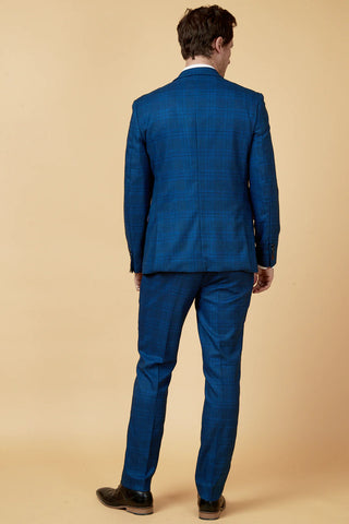 Man wearing a blue suit against a beige background