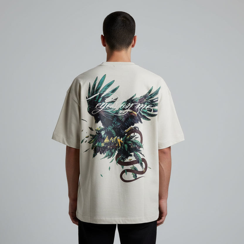 Person wearing a white t-shirt with a graphic design on the back, standing against a plain background