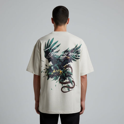 Person wearing a white t-shirt with a graphic design on the back, standing against a plain background