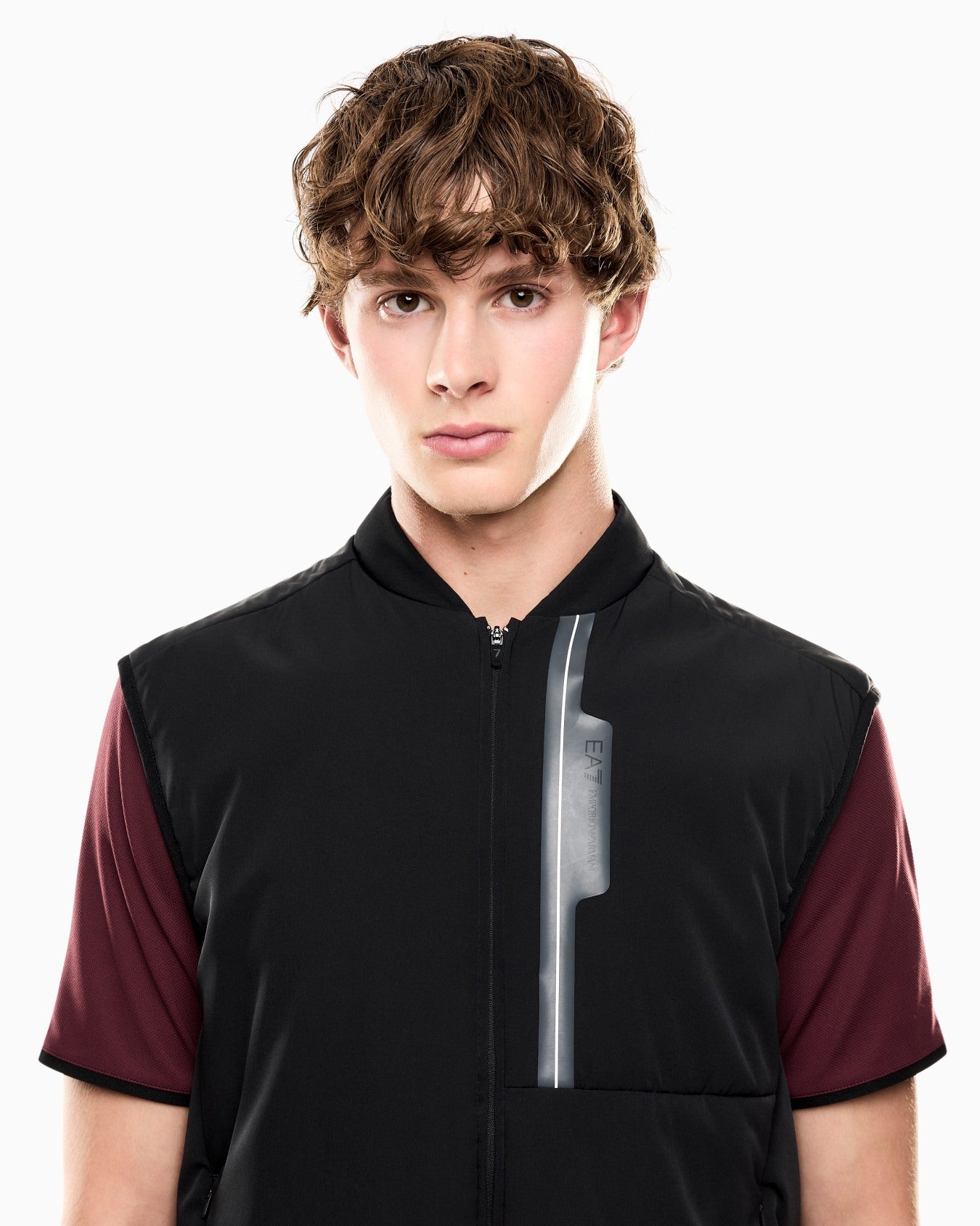 Person wearing a black and red shirt with a white background