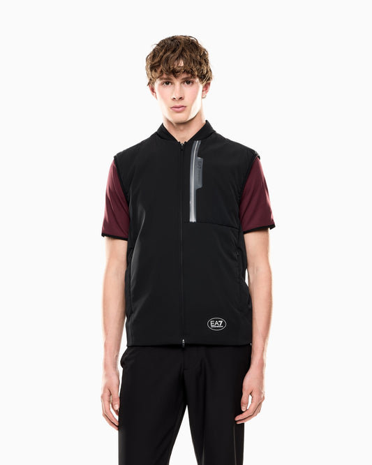 Person wearing a black and maroon vest with a visible brand logo on a white background