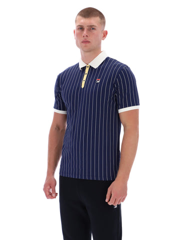 Man wearing a navy striped polo shirt with white accents on a white background