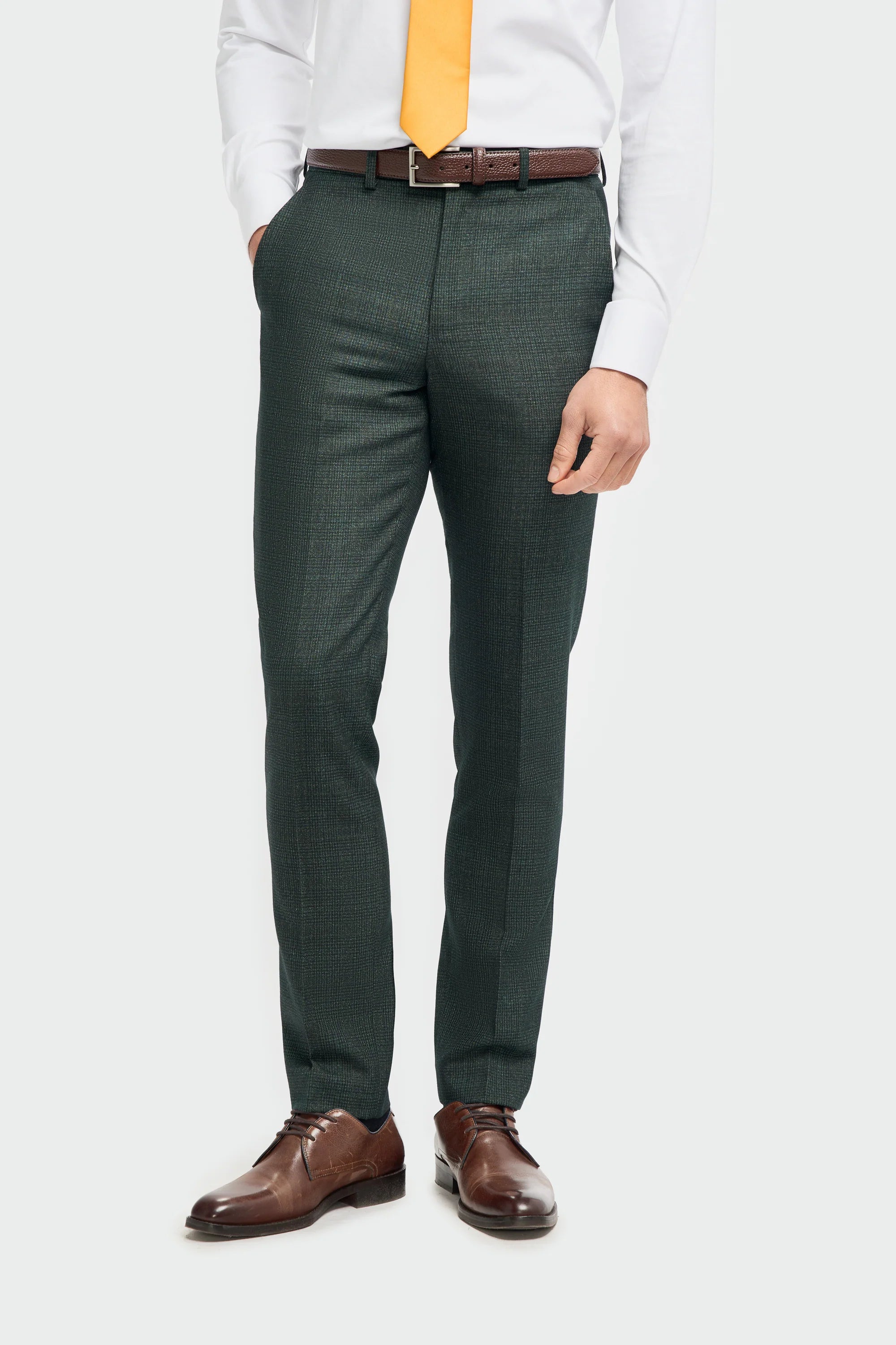 Green pants worn by a person with a plain background
